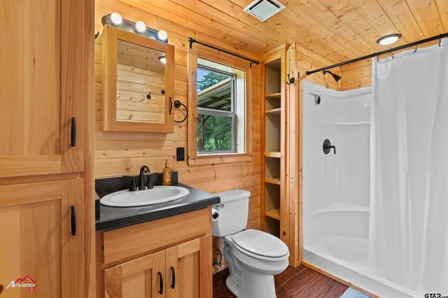 a bathroom with a sink toilet and shower