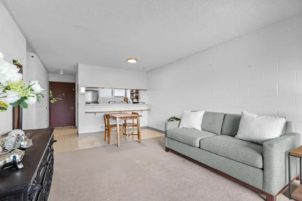 a living room with furniture and flowers