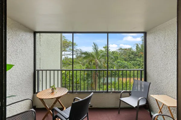 a balcony with table and chairs