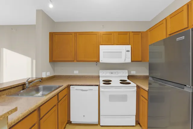 a kitchen with a sink stove and refrigerator