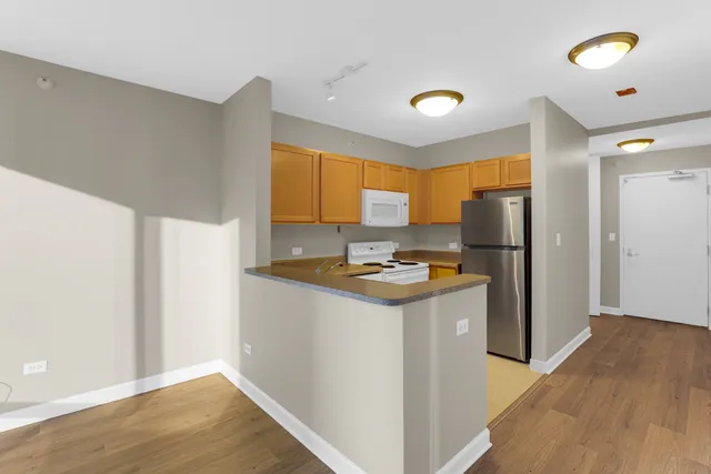 a kitchen with stainless steel appliances a refrigerator and a stove