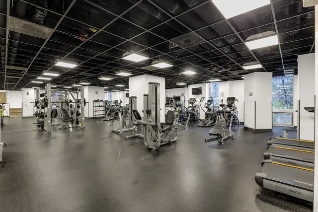 a living room with furniture and large windows