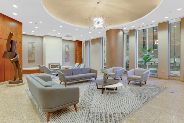 a living room with furniture and a chandelier