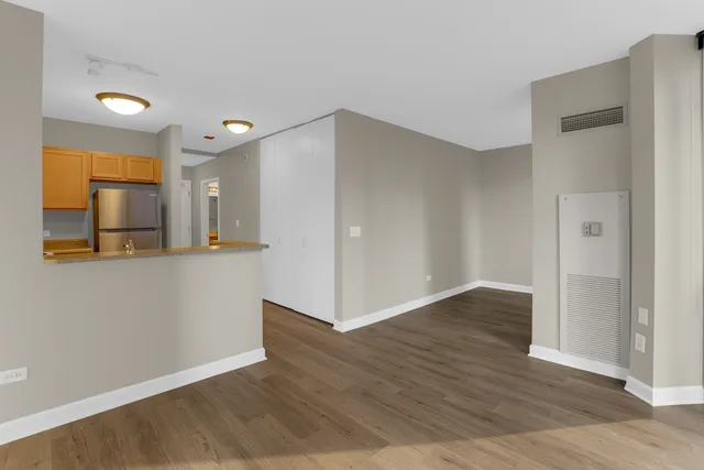 a view of a kitchen with wooden floor and a sink