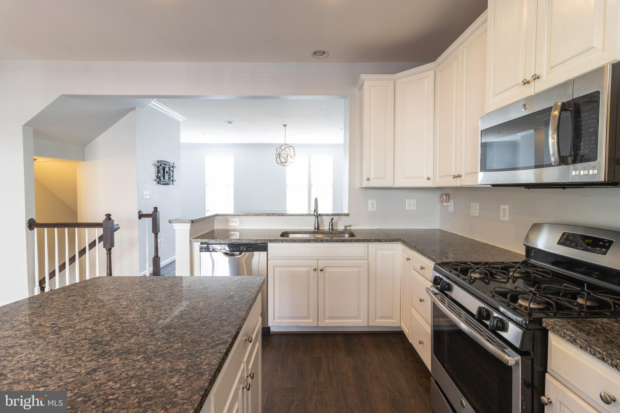 1044 Ramble Run Road Baltimore, MD 21220 - Photo 15 of 37 a kitchen with stainless steel appliances granite countertop a stove and a sink