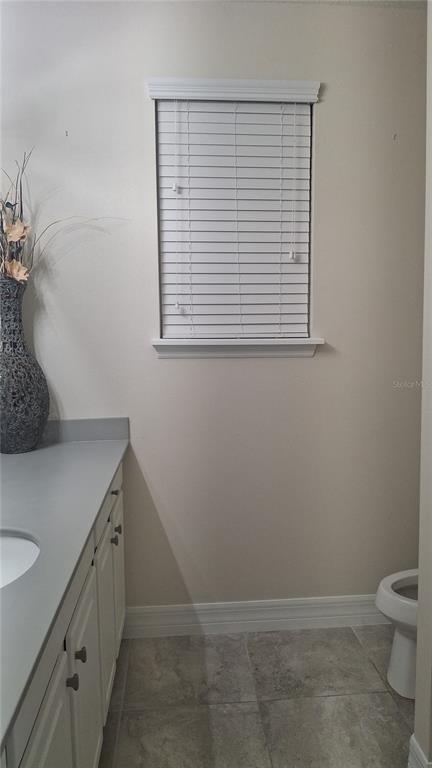 2840 Chantilly Avenue Kissimmee, FL 34741 - Photo 19 of 22 a bathroom with a sink and a toilet