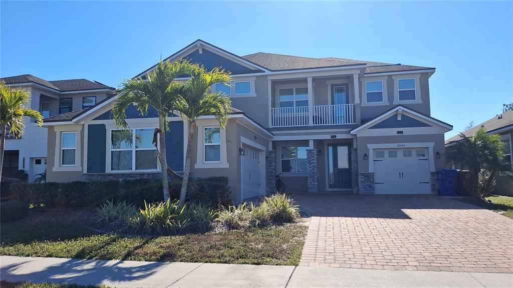 2840 Chantilly Avenue Kissimmee, FL 34741 - Photo 2 of 22 a front view of a house with garden