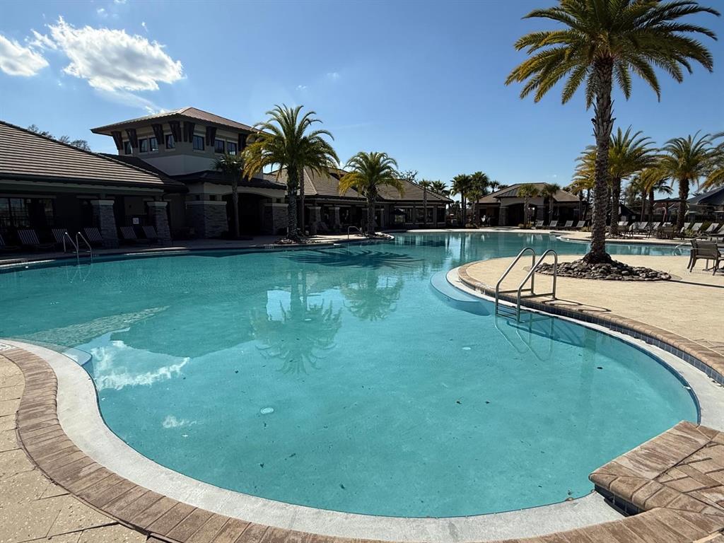 2840 Chantilly Avenue Kissimmee, FL 34741 - Photo 8 of 22 a view of a swimming pool with a garden