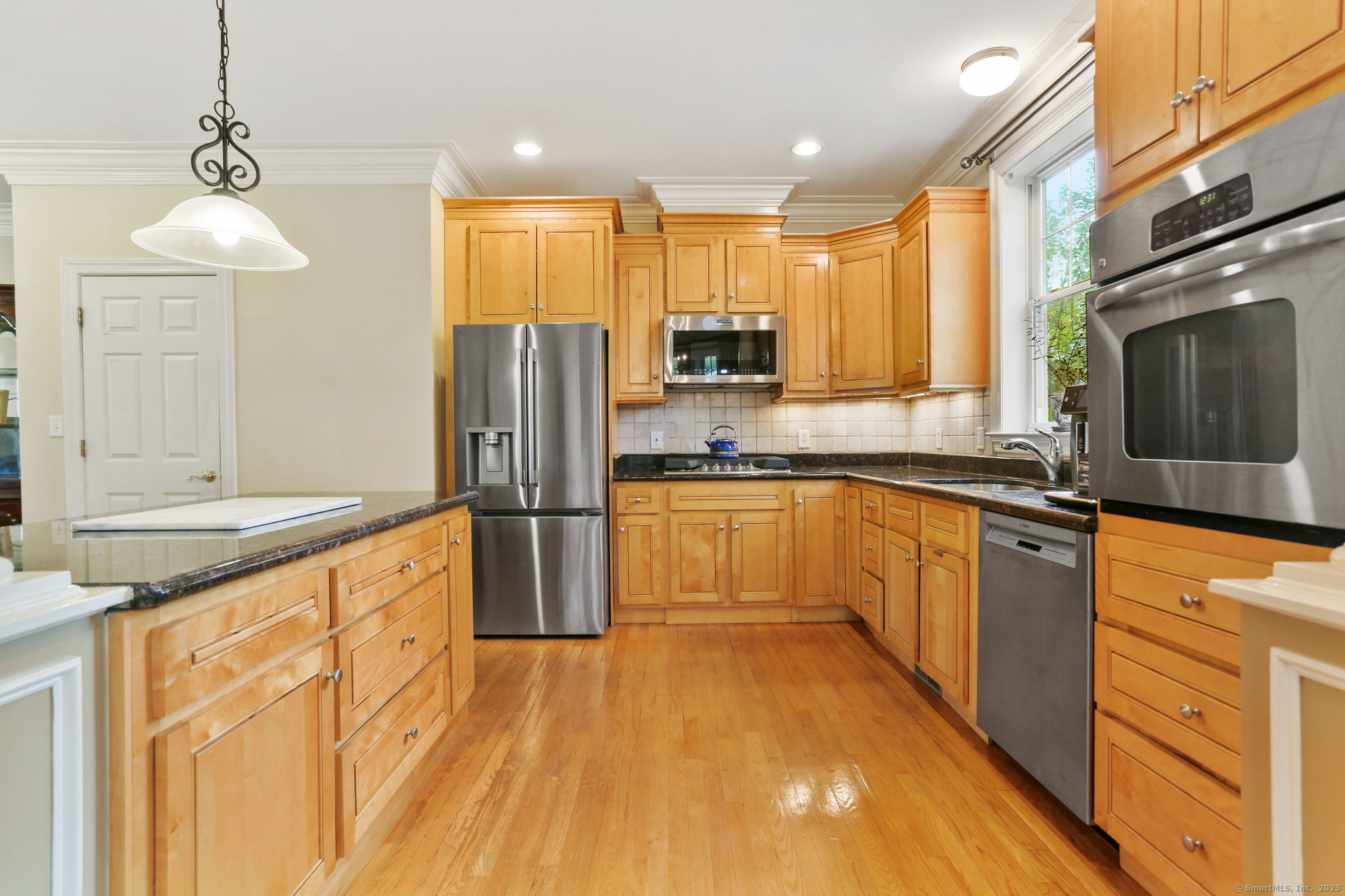 25 Country Road, Unit 25 Fairfield, CT 06824 - Photo 19 of 40 a kitchen with stainless steel appliances granite countertop a refrigerator a sink dishwasher a stove with wooden cabinets and floor