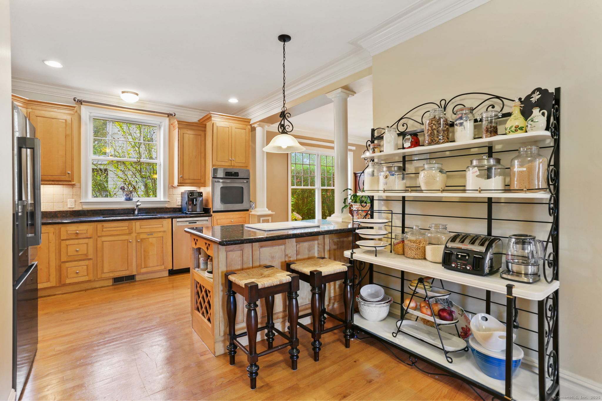 25 Country Road, Unit 25 Fairfield, CT 06824 - Photo 22 of 40 a kitchen with stainless steel appliances granite countertop a stove a sink and a refrigerator with wooden floor