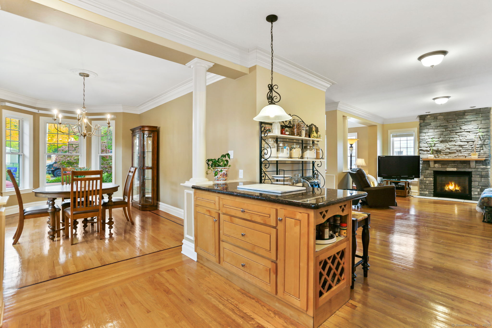 25 Country Road, Unit 25 Fairfield, CT 06824 - Photo 23 of 40 a kitchen with stainless steel appliances granite countertop a stove and a dining table with wooden floor