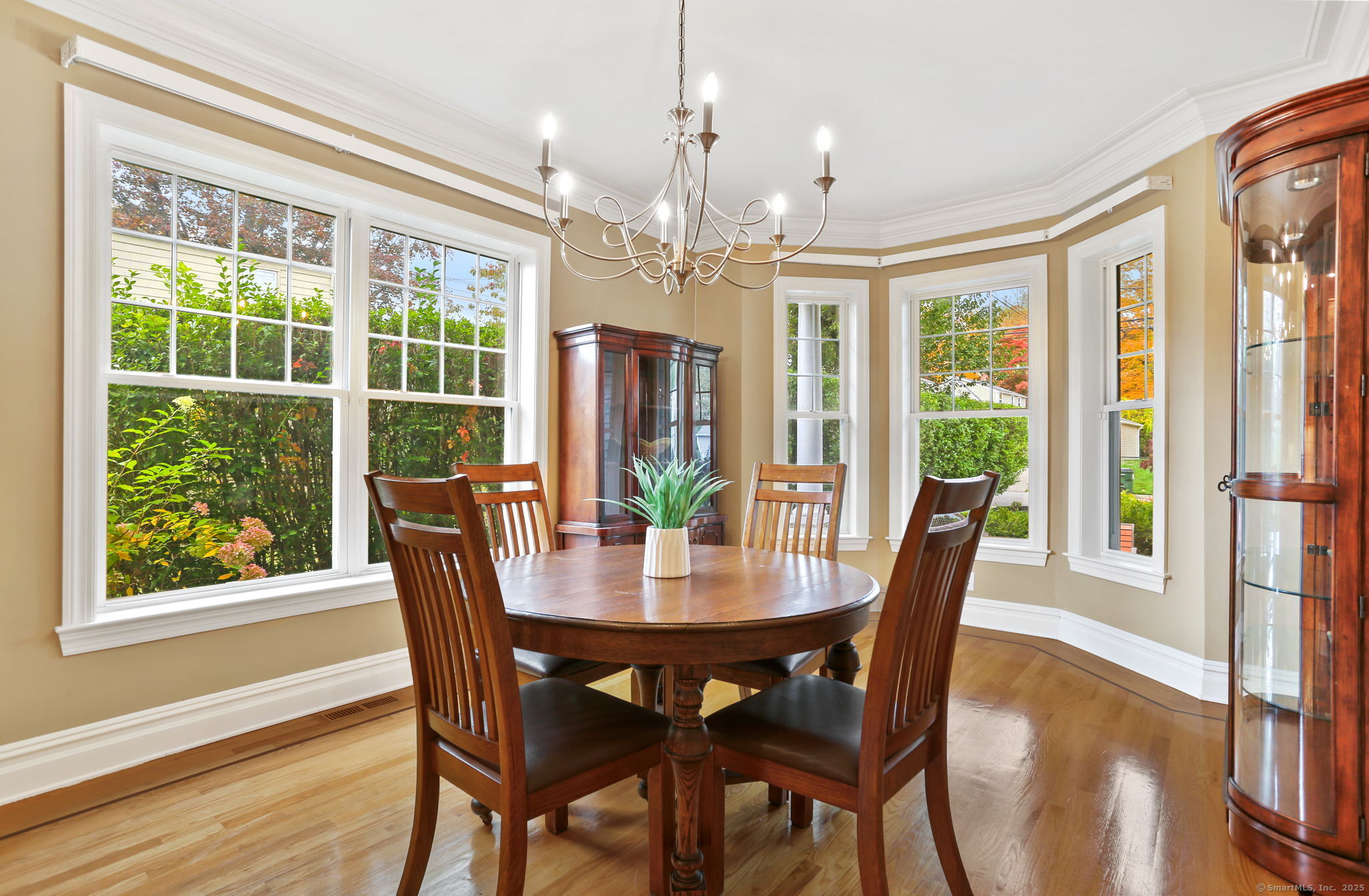 25 Country Road, Unit 25 Fairfield, CT 06824 - Photo 25 of 40 a view of a dining room with furniture large windows and wooden floor