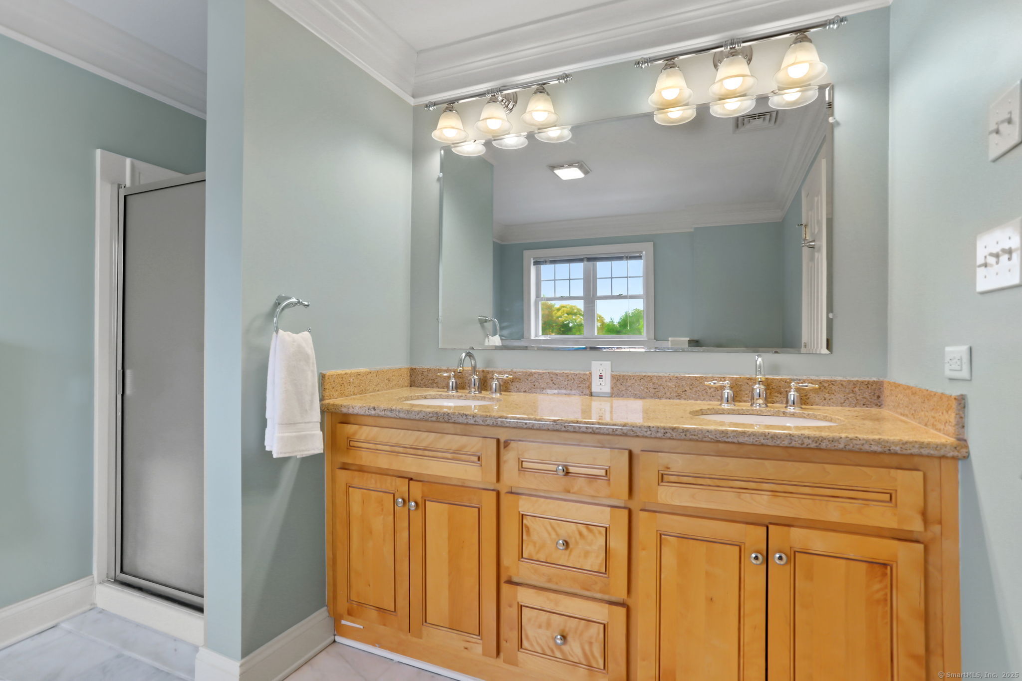 25 Country Road, Unit 25 Fairfield, CT 06824 - Photo 37 of 40 a bathroom with a granite countertop sink a light fixture and a mirror