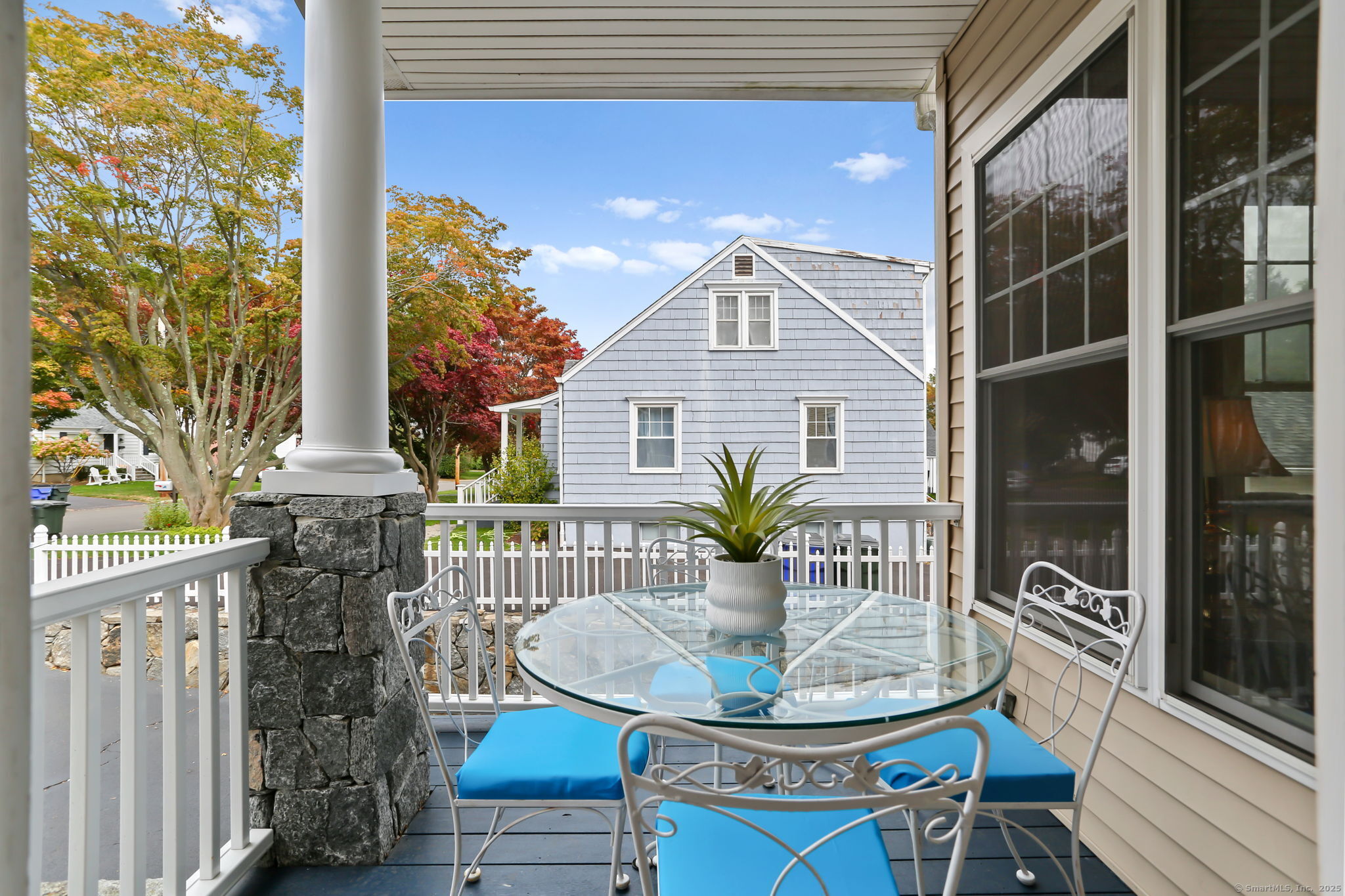 25 Country Road, Unit 25 Fairfield, CT 06824 - Photo 5 of 40 a front view of a house with a garden and patio