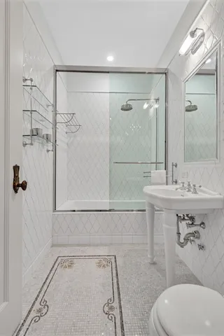 a bathroom with a sink toilet and shower