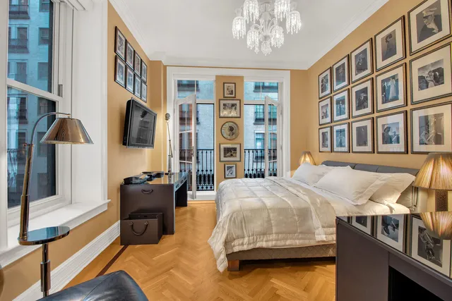 a bedroom with bed and a flat screen tv