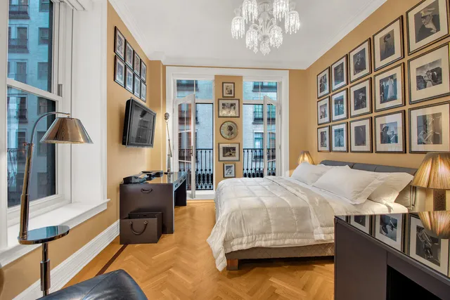 a bedroom with bed and a flat screen tv