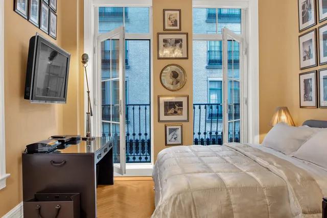 a bedroom with bed and cabinets