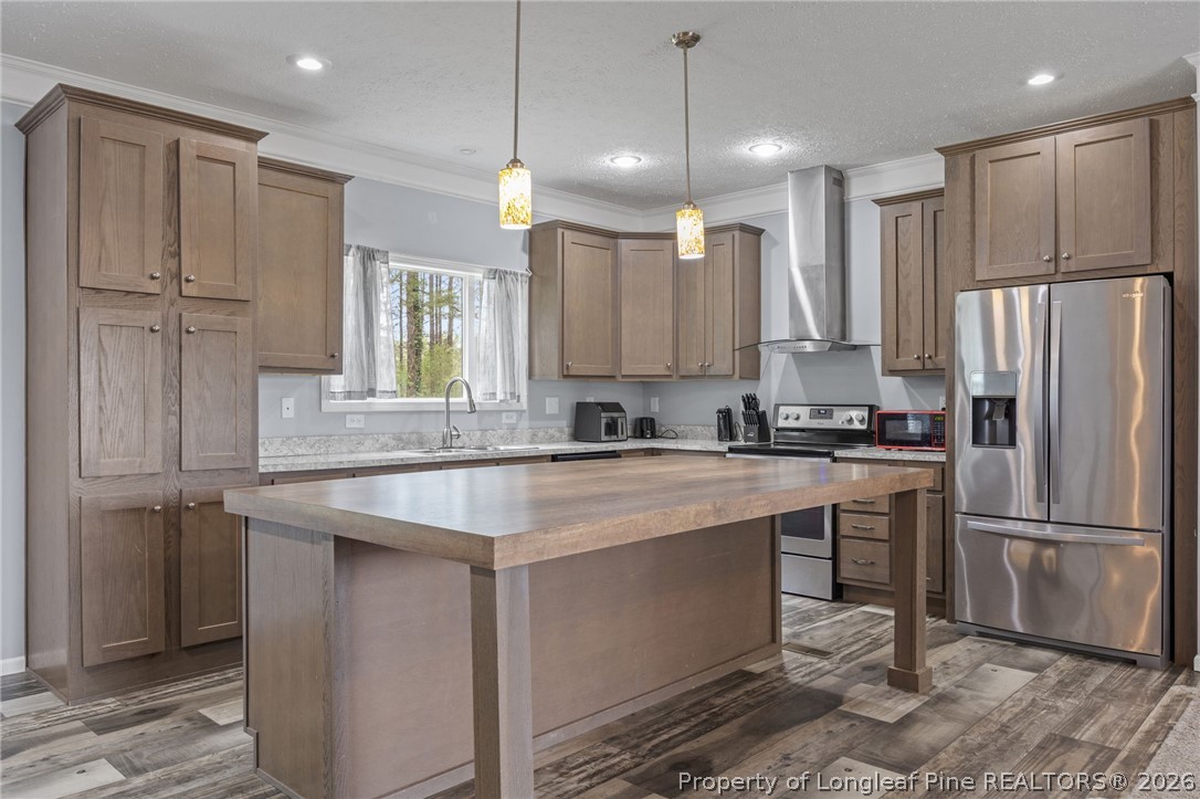 2252 Old Stage Road South Erwin, NC 28339 - Photo 5 of 47 a kitchen with kitchen island granite countertop a refrigerator a sink and white cabinets