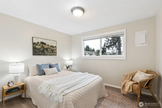 a bedroom with a bed and a chair