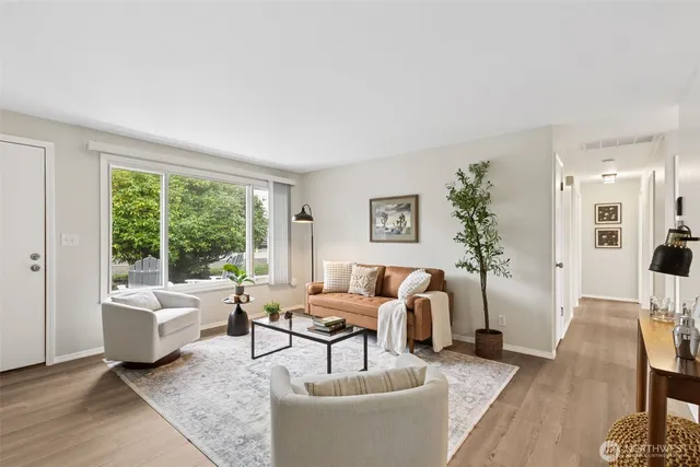 a living room with furniture and a large window