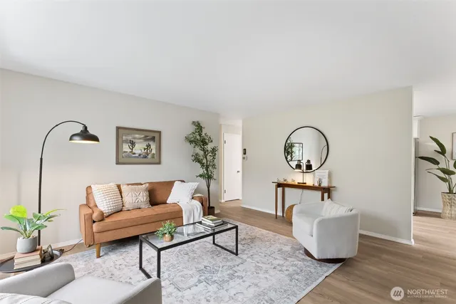 a living room with furniture and a potted plant