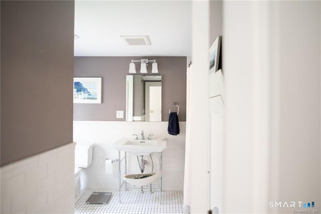 57 Mill Rock Road Hamden, CT 06517 - Photo 13 of 24 a bathroom with a sink and a mirror