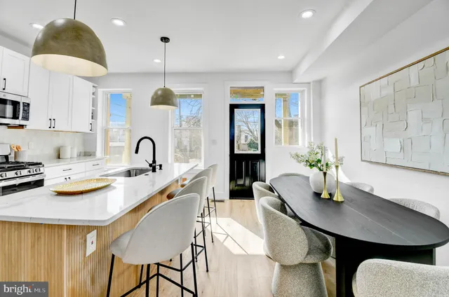 a kitchen that has a table and chairs in it