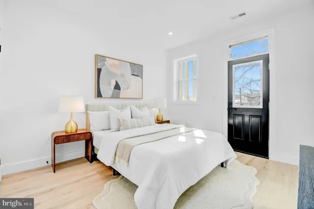 a bedroom with a bed and a lamp