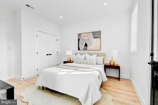 a bedroom with a bed and a night stand