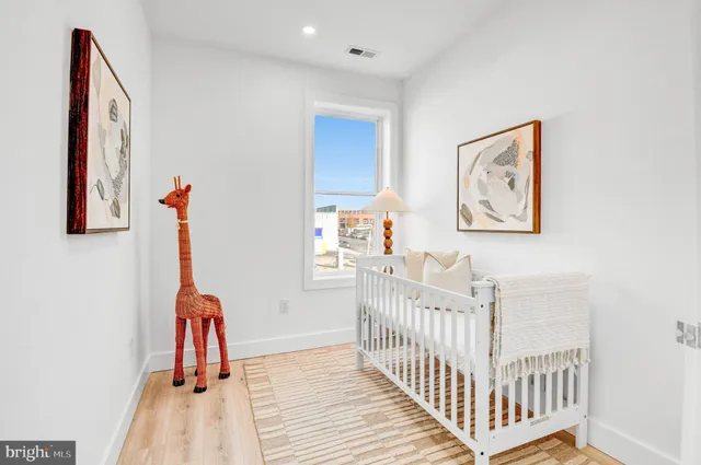 a view of a bedroom with furniture and wooden floor