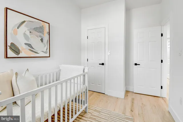 a view of hallway with furniture and wooden floor