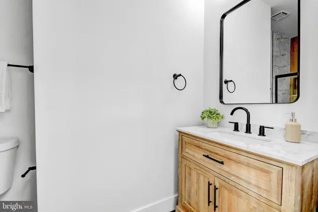 a view of bathroom with a sink and a mirror