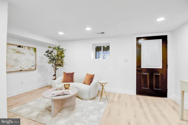 a living room with furniture and a painting on the wall