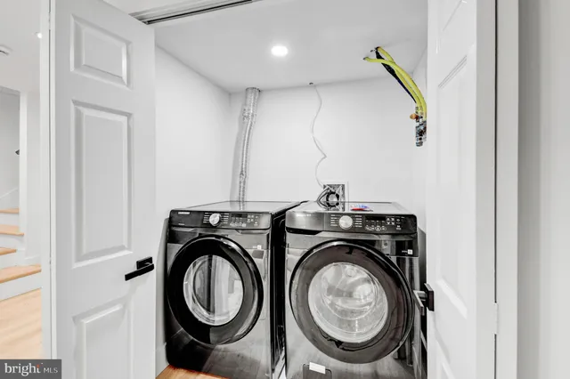 a view of storage and utility room with washer and dryer