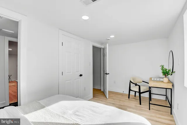 a bedroom with a bed and a potted plant