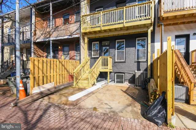 a view of a house with large windows and a small yard