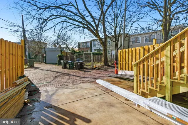 a view of street with wooden fence