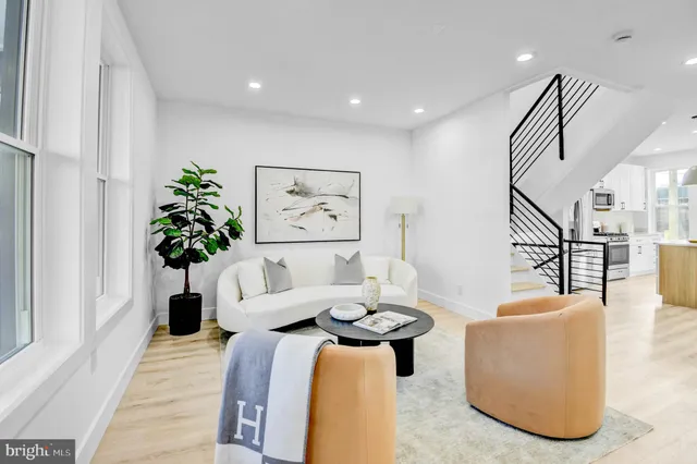 a living room with furniture potted plant and a chandelier