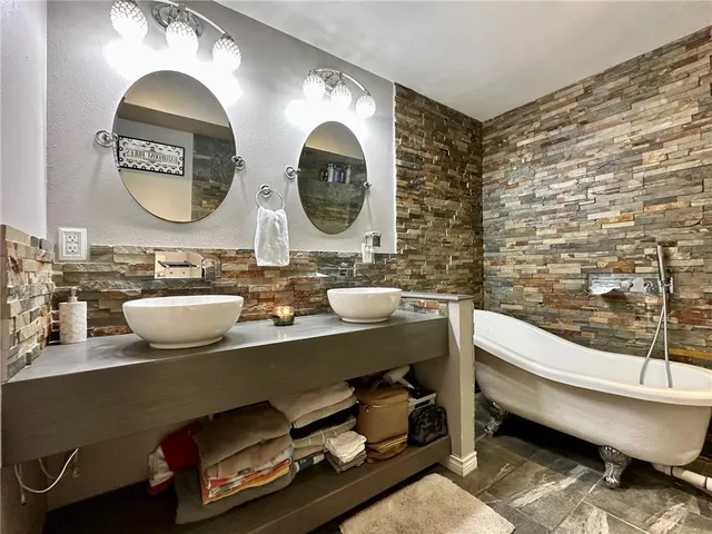 a bathroom with a double vanity sink and a mirror