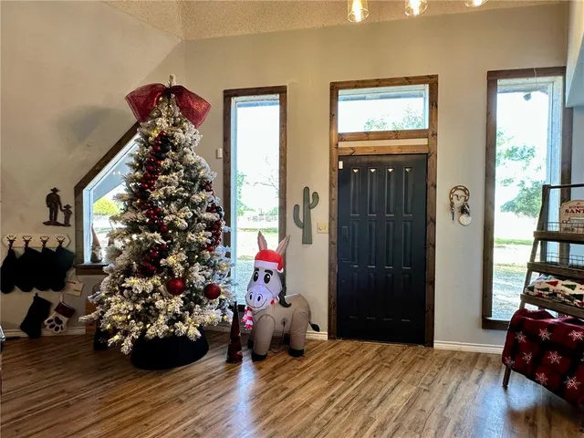 a view of a entryway of a livingroom with wooden floor