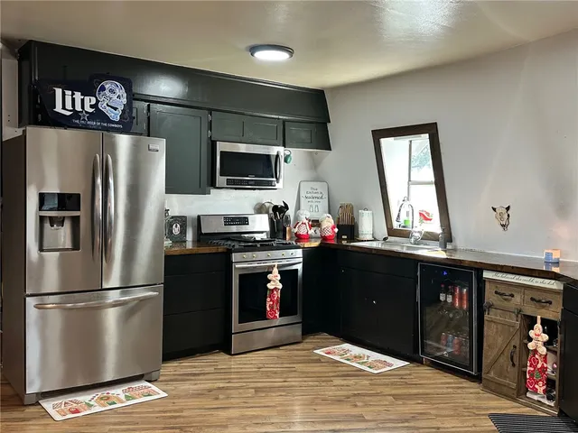 a kitchen with stainless steel appliances granite countertop a refrigerator and a microwave
