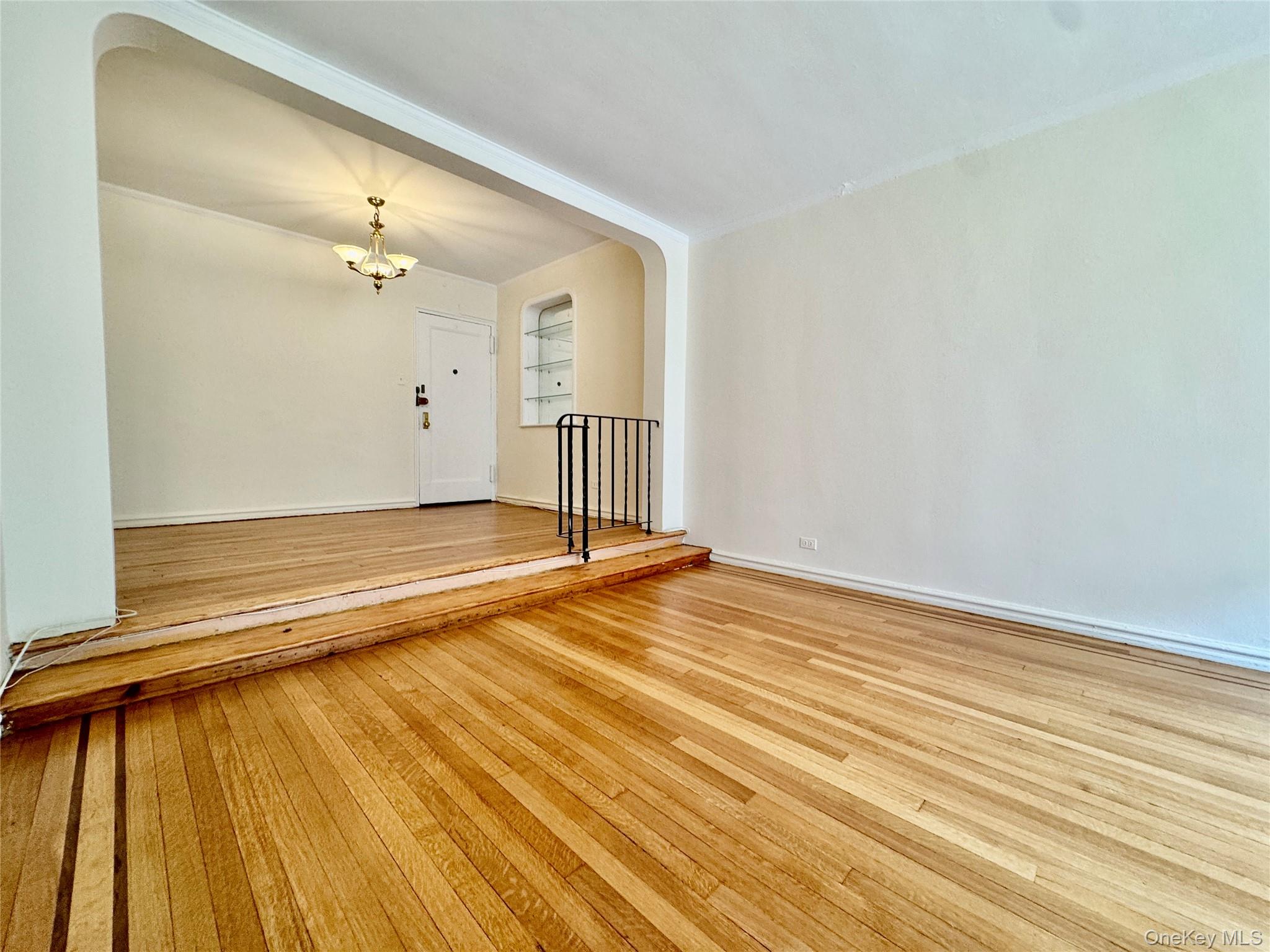 113-14 72nd Road, Unit 1M Queens, NY 11375 - Photo 7 of 20 a view of a room with wooden floor and door