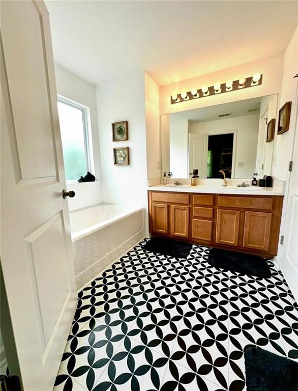 4832 Batiste Lane Acworth, GA 30101 - Photo 17 of 27 a bathroom with a sink a mirror and a bathtub