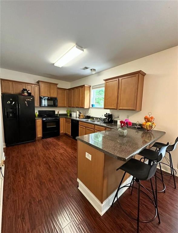 4832 Batiste Lane Acworth, GA 30101 - Photo 9 of 27 a kitchen with stainless steel appliances granite countertop a refrigerator a stove top oven a sink dishwasher and wooden floor