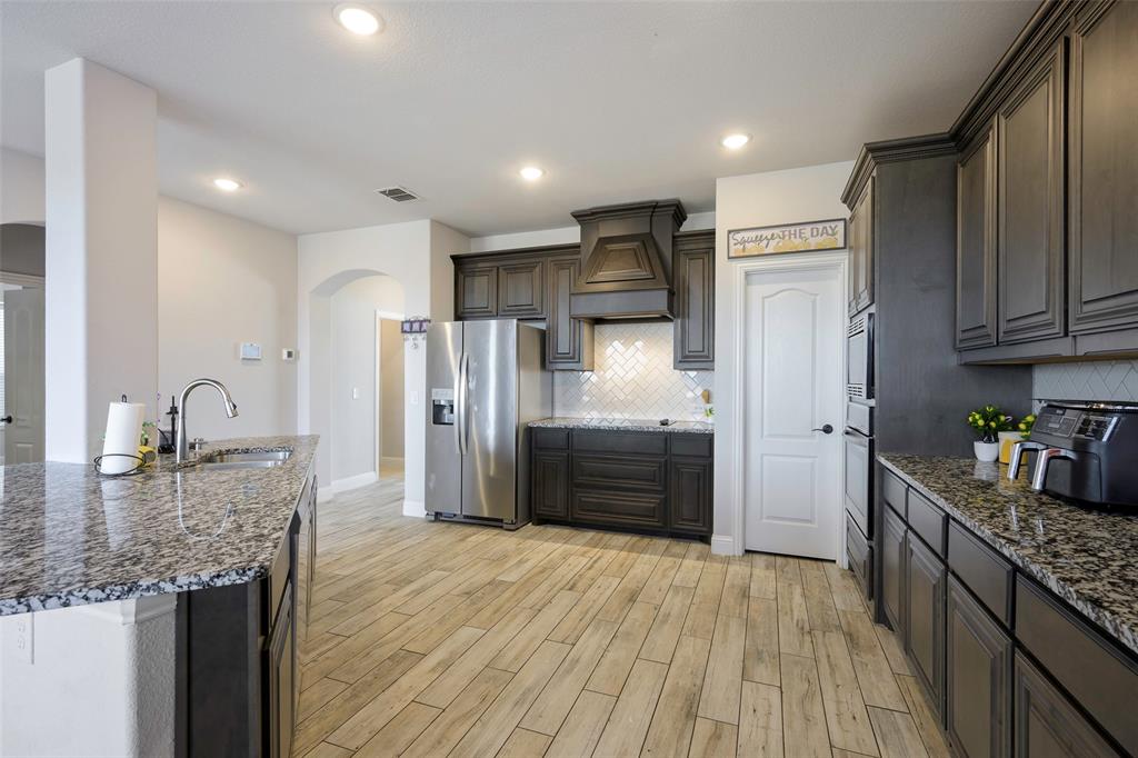4059 Three Forks Road Kaufman, TX 75142 - Photo 5 of 25 a kitchen with stainless steel appliances granite countertop a refrigerator and a sink