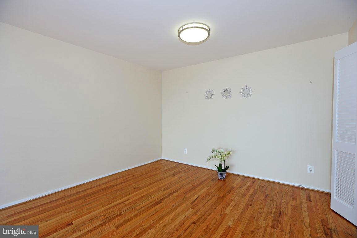 9701 Fields Road, Unit 603 Gaithersburg, MD 20878 - Photo 11 of 29 a view of a room with wooden floor and white walls