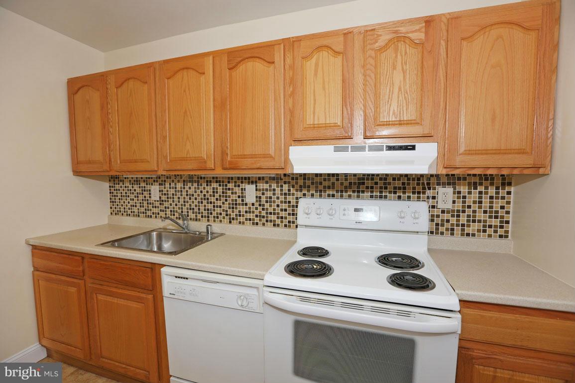 9701 Fields Road, Unit 603 Gaithersburg, MD 20878 - Photo 13 of 29 a kitchen with a stove and a sink