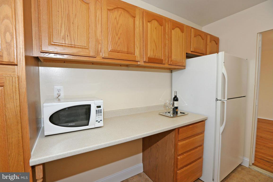 9701 Fields Road, Unit 603 Gaithersburg, MD 20878 - Photo 14 of 29 a kitchen with stainless steel appliances granite countertop a refrigerator sink and cabinets
