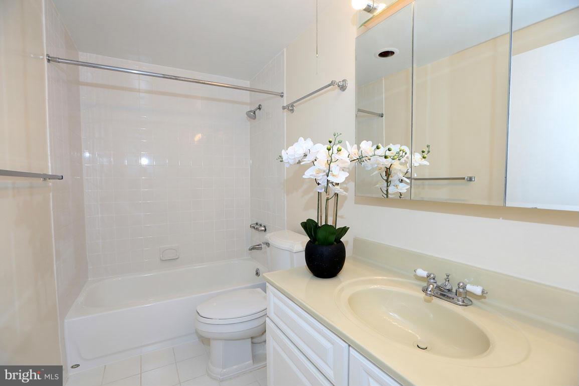 9701 Fields Road, Unit 603 Gaithersburg, MD 20878 - Photo 17 of 29 a bathroom with a sink a toilet and shower